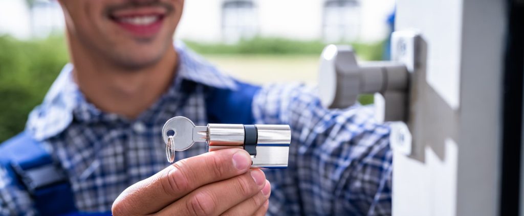 Locksmith Lock Door Repair. Worker Changing And Cylinder