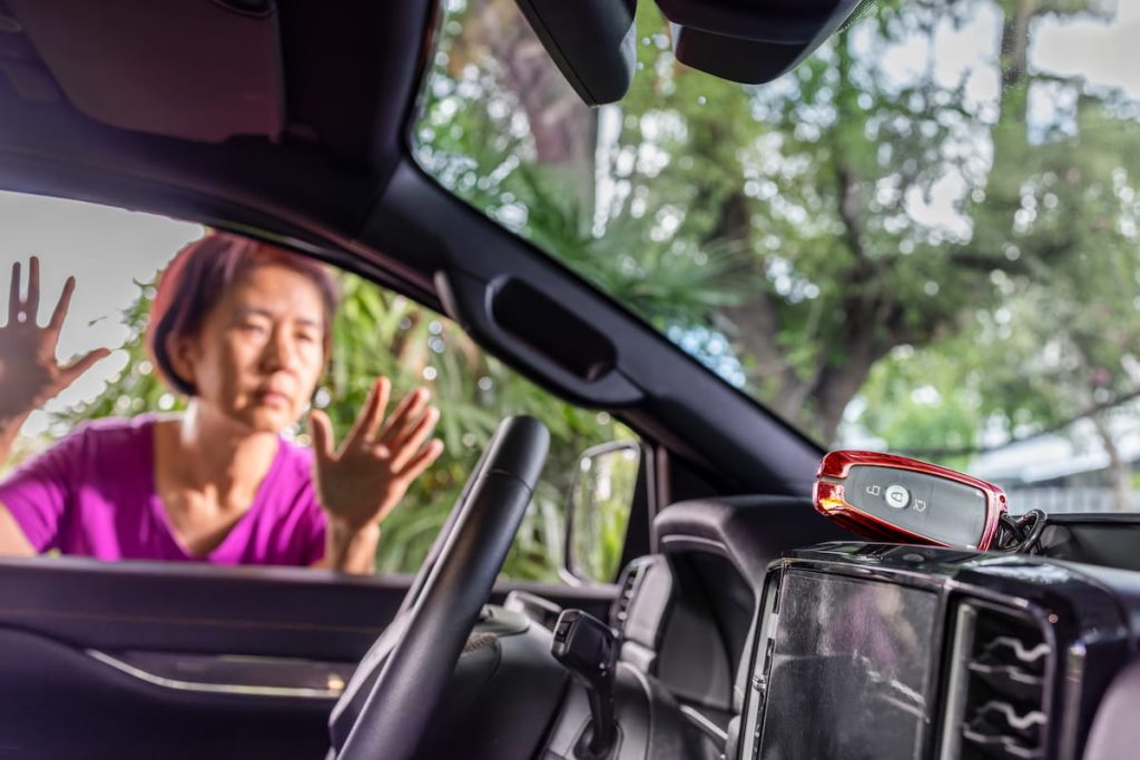 Senior asian woman forgot her key inside locked car